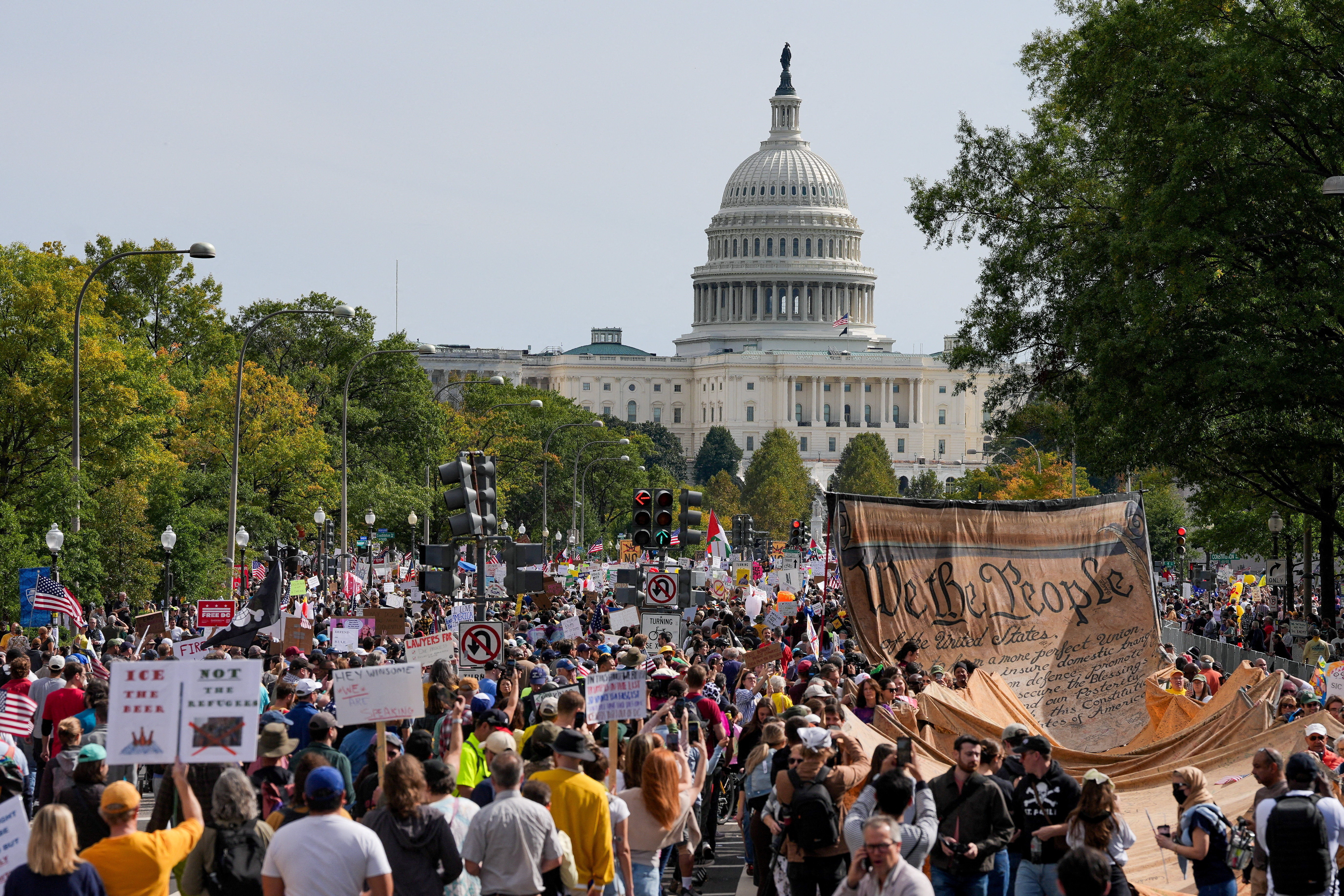 Citizens marching at the Capitol with We the People banner
